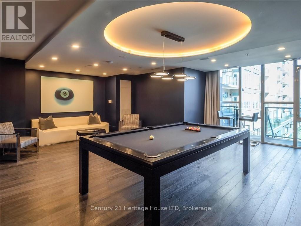 A pool table in a room with a view of the city.