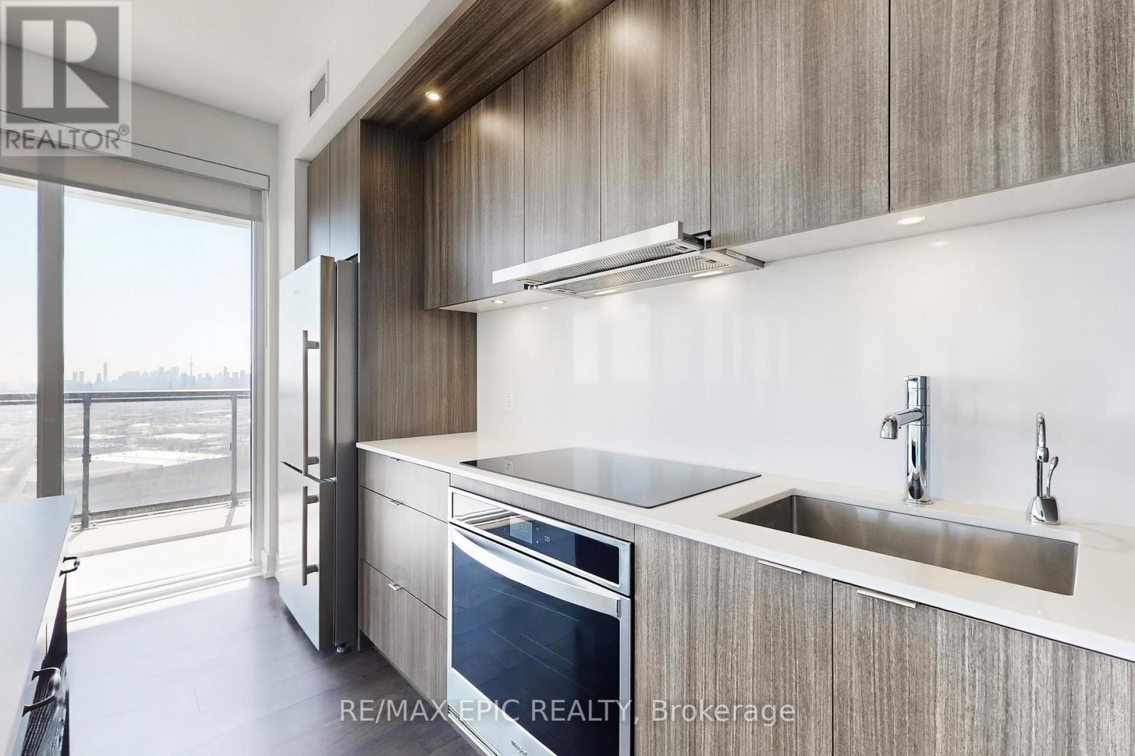 A modern kitchen with wooden cabinets and stainless steel appliances.