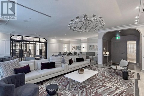 A living room with a white couch and a chandelier.