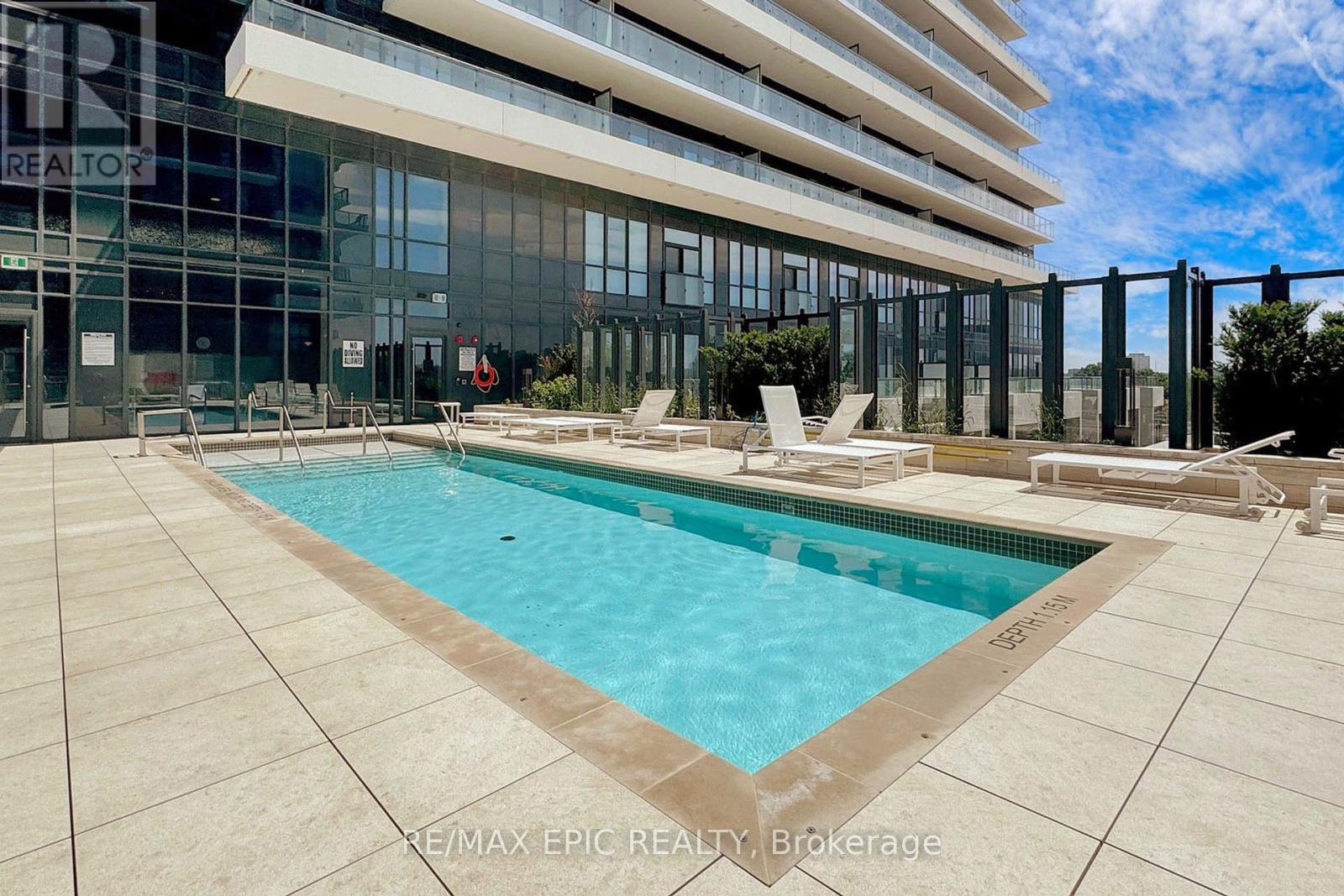 A swimming pool in front of a modern building.