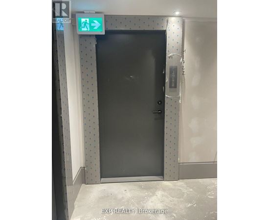 A black door with a sign above it that says "EXIT".