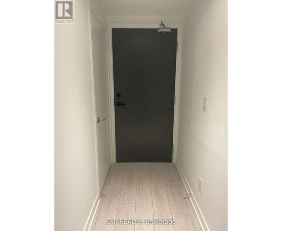 A black door in a white hallway.