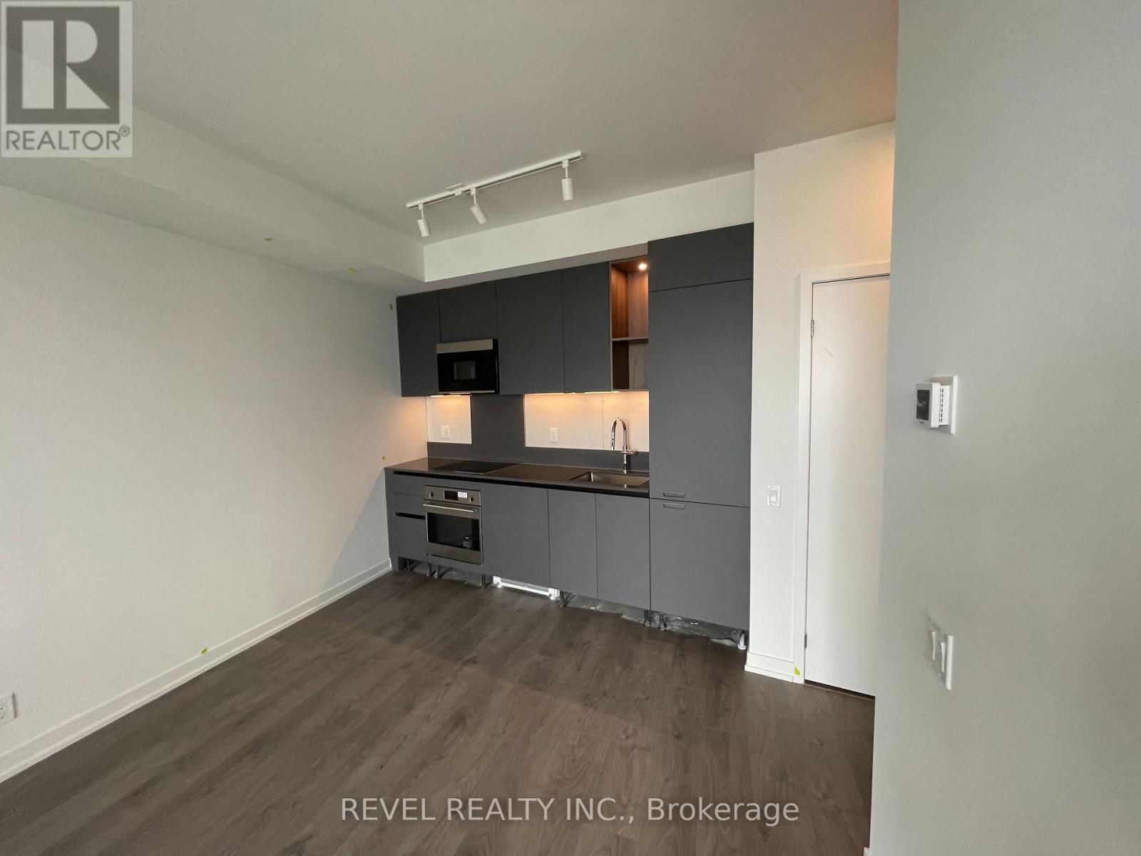 A kitchen area with a counter and cabinets.