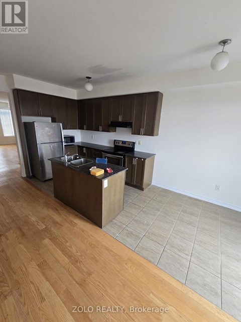 A kitchen with wooden floors and white walls.