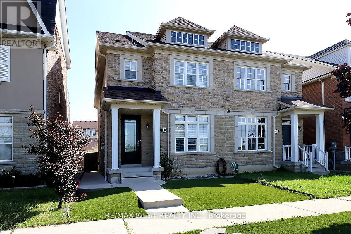 A house with a stone facade and a black door is for sale.