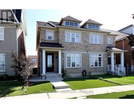 A house with a stone facade and a black door is for sale.