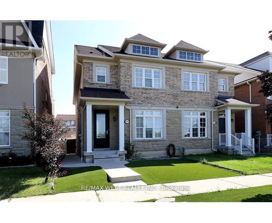 A house with a stone facade and a black door is for sale.