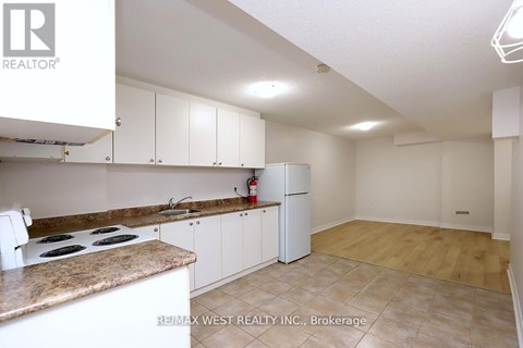 A kitchen with white cabinets and a countertop.