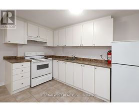 A kitchen with white appliances and cabinets.