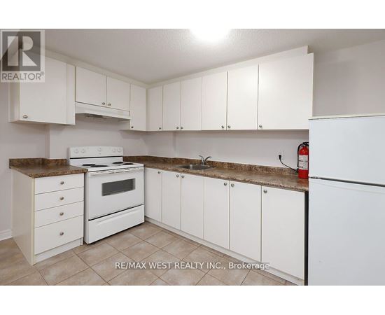 A kitchen with white appliances and cabinets.