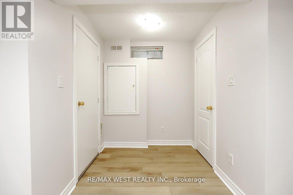 A white hallway with a door on the left and a door on the right.
