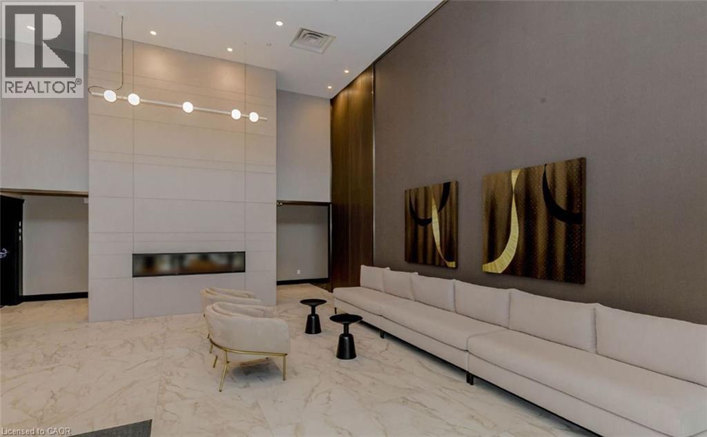 A modern living room with a white sofa and a fireplace.
