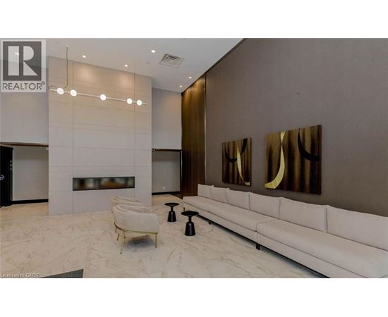 A modern living room with a white sofa and a fireplace.