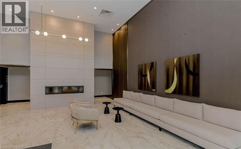 A modern living room with a white sofa and a fireplace.