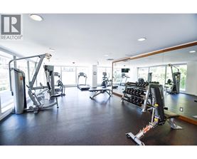 A gym with a variety of equipment including treadmills, weights, and exercise machines.