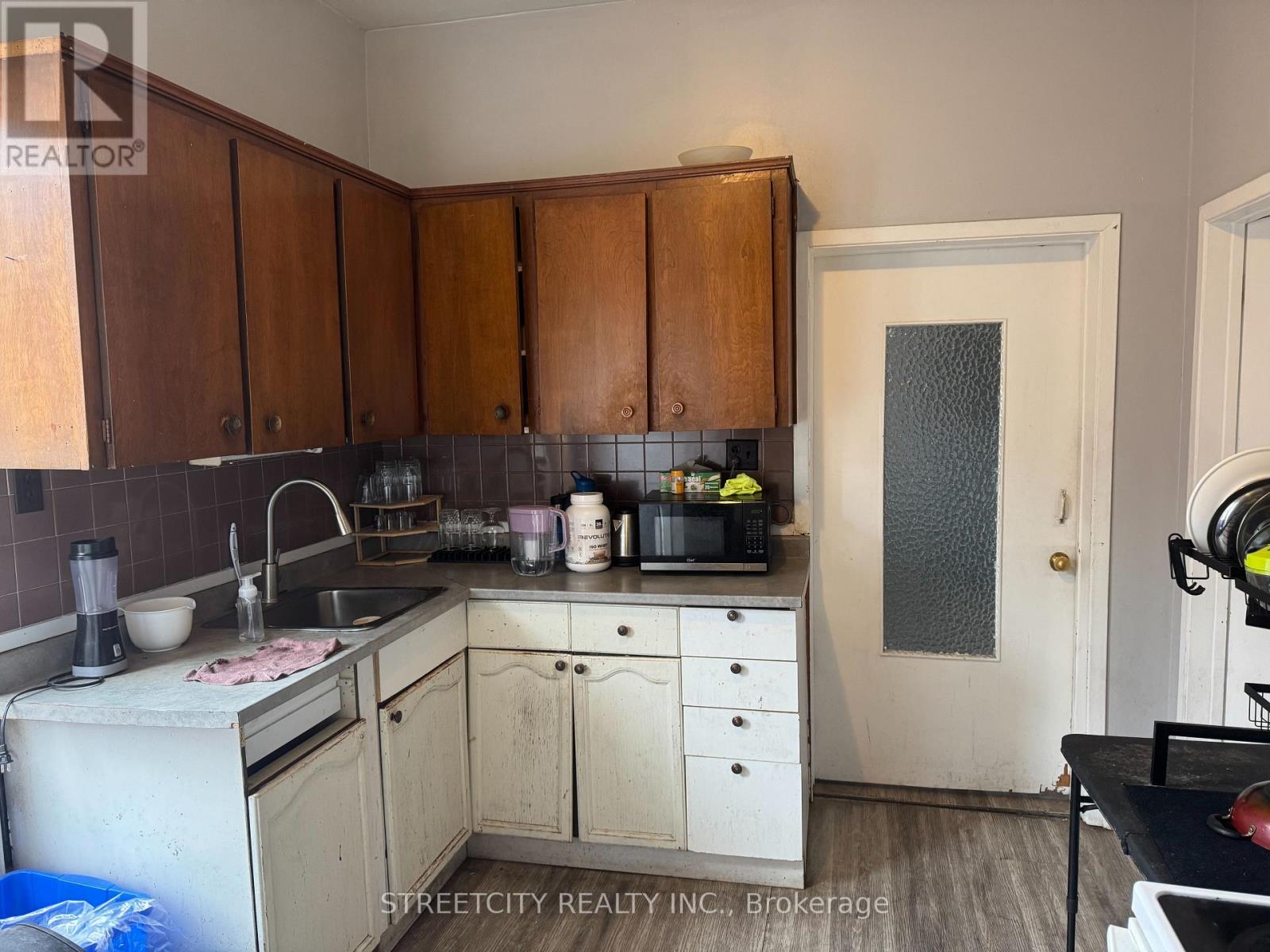 A kitchen with wooden cabinets and a sink.