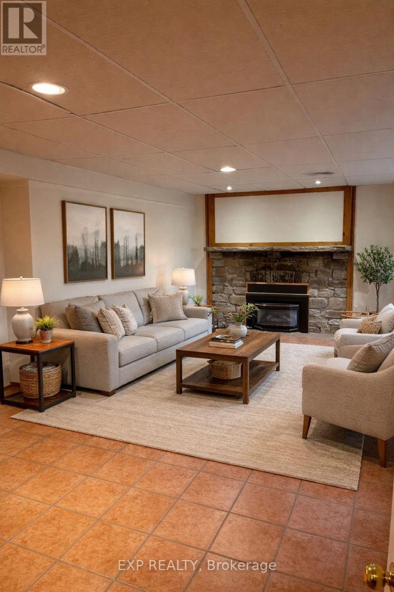 A living room with a couch, a chair, a coffee table, and a fireplace.