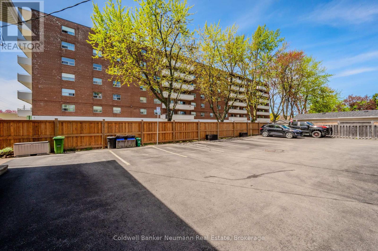 A parking lot with a car and a building in the background.