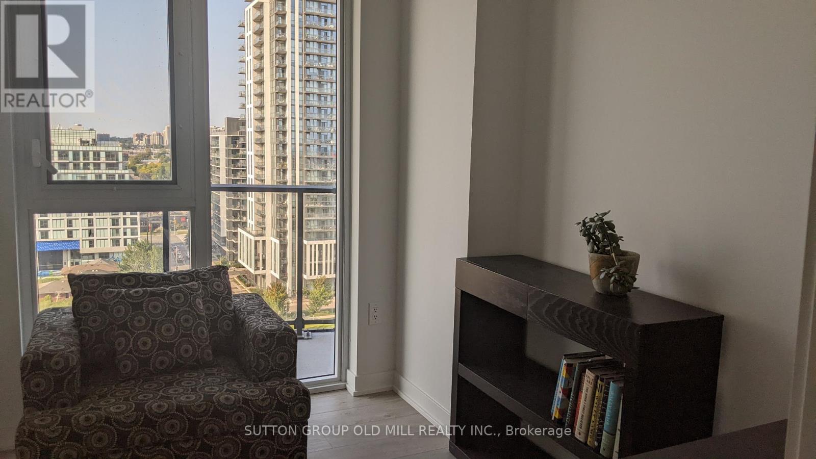 A living room with a chair and a bookshelf.