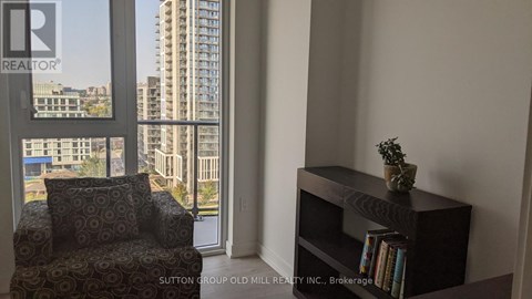 A living room with a chair and a bookshelf.