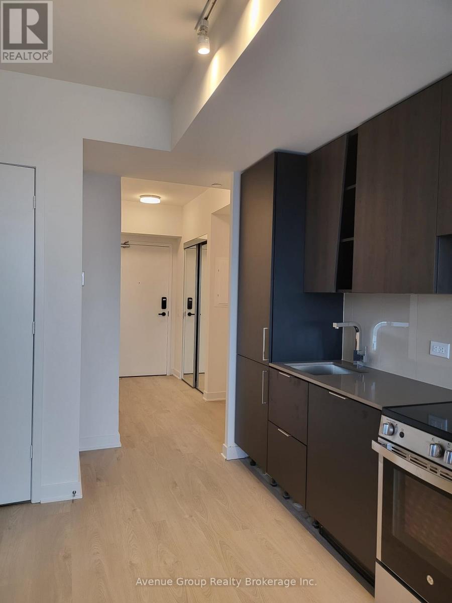 A kitchen with brown cabinets and a stove top oven.