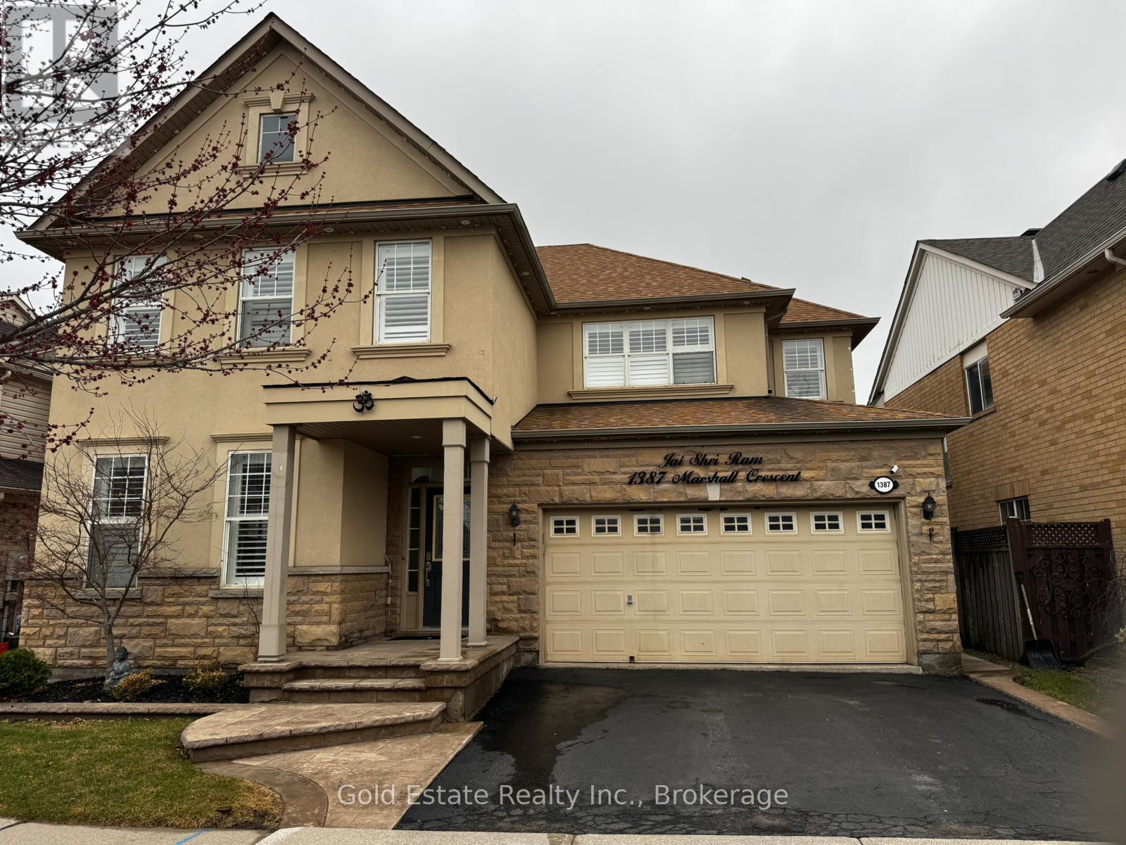 A house with a brown roof and a beige garage door.
