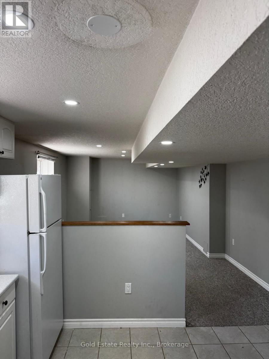 A kitchen with a refrigerator and a counter top.
