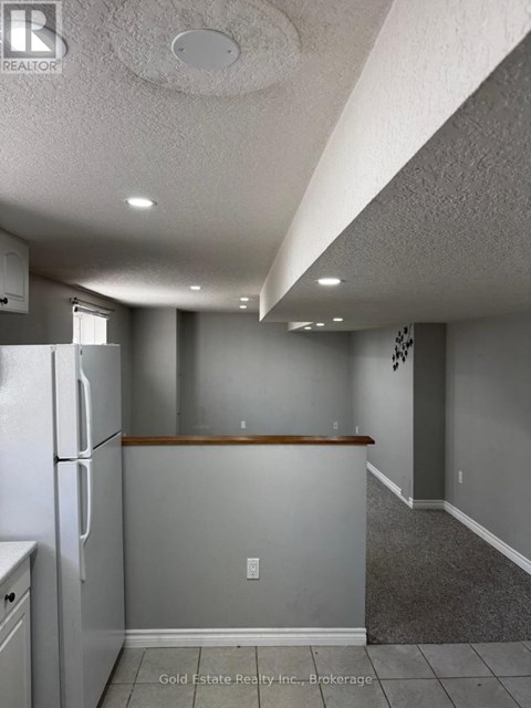A kitchen with a refrigerator and a counter top.