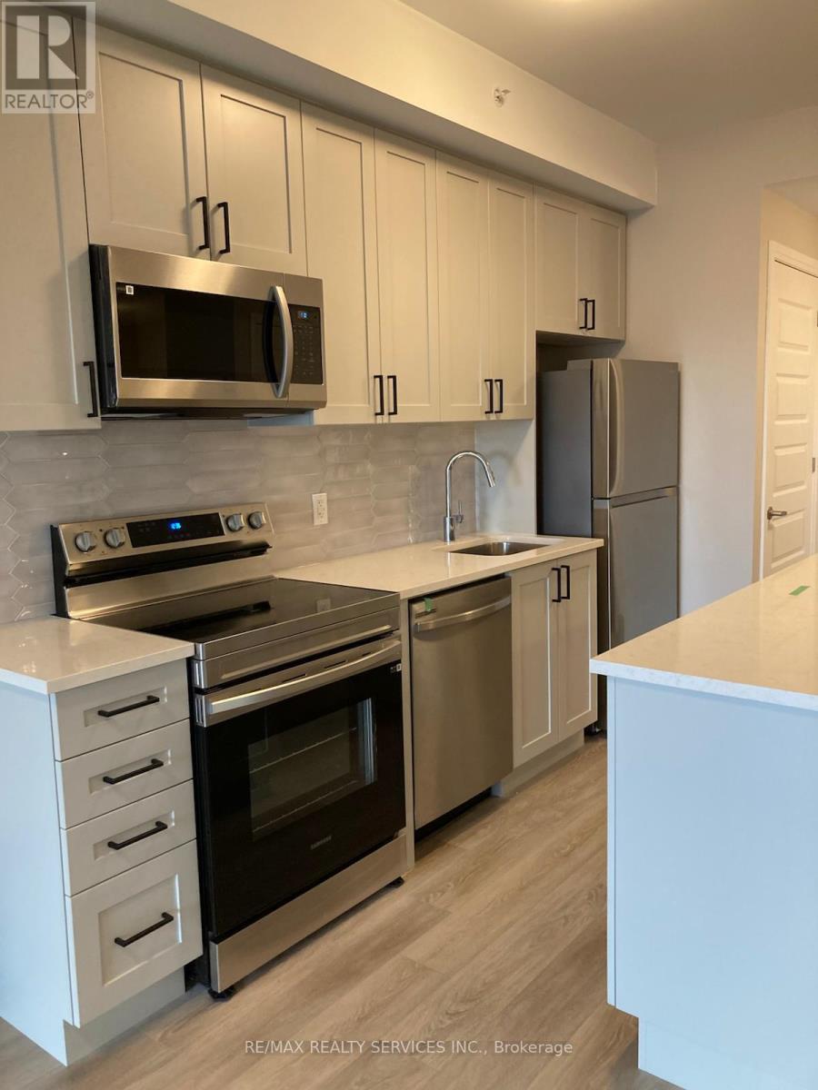 A modern kitchen with stainless steel appliances and white cabinets.