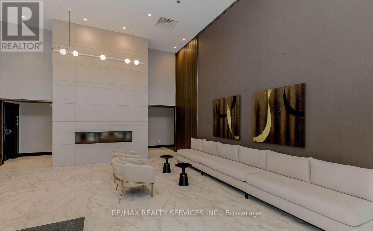 A modern living room with a white sofa and a fireplace.