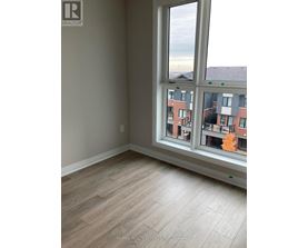 A room with a large window overlooking a residential area.