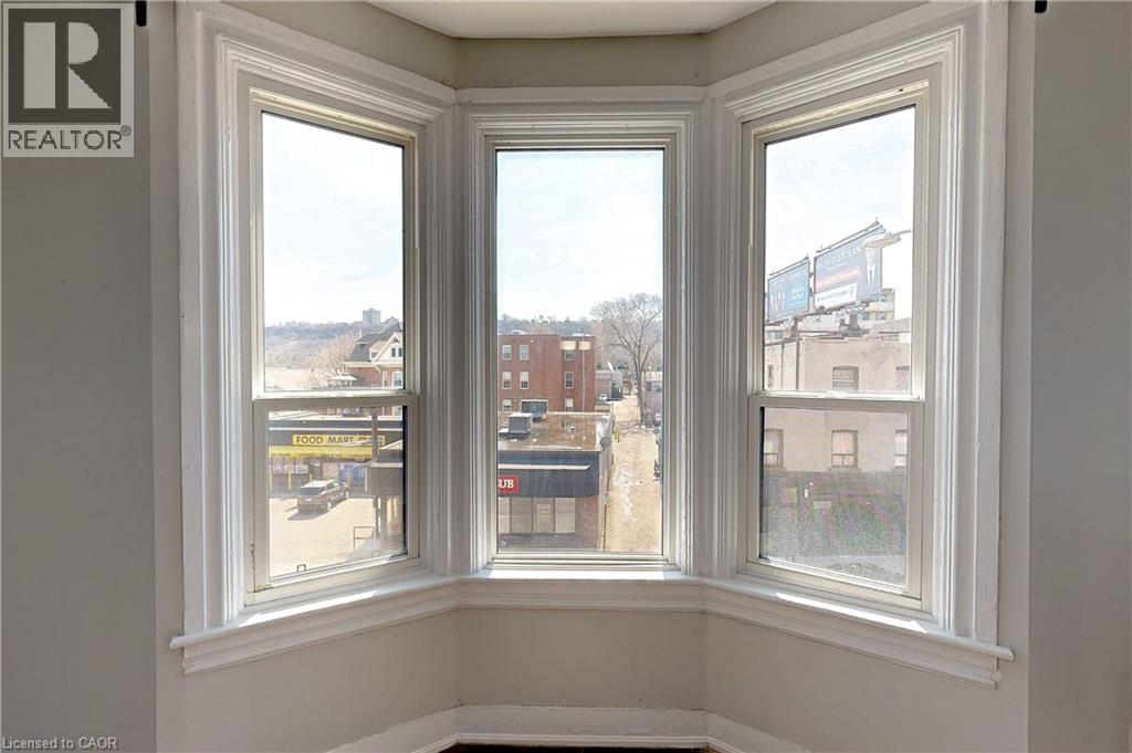 A room with three windows showing an outdoor view.
