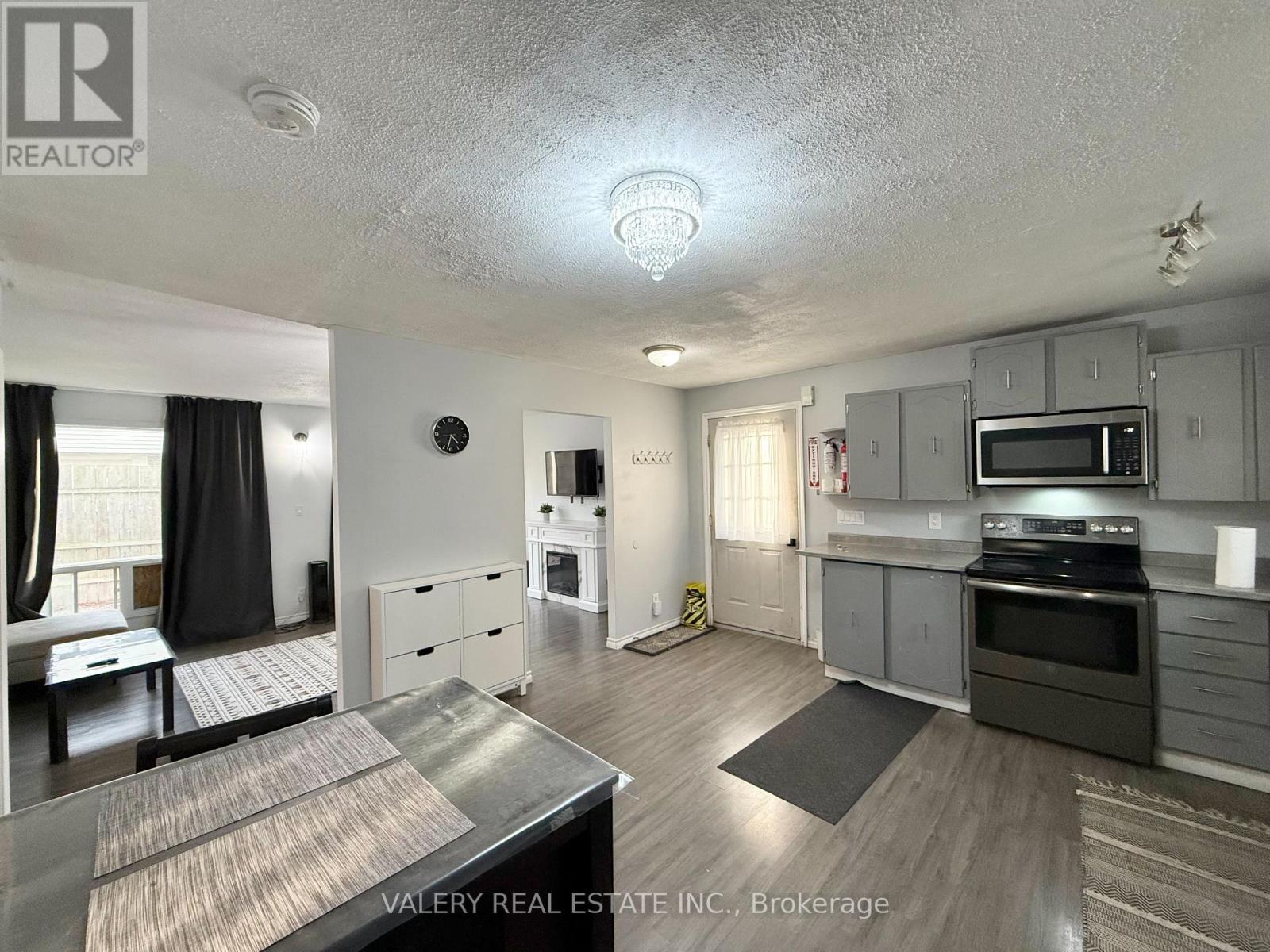 A kitchen with a stove top oven and microwave.