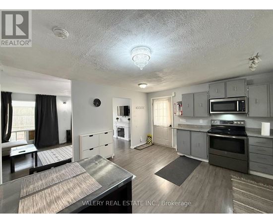 A kitchen with a stove top oven and microwave.