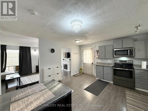 A kitchen with a stove top oven and microwave.