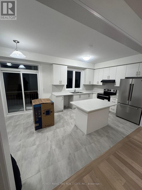 A kitchen with a white counter top and a refrigerator.