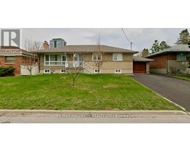 A house with a lawn in front of it is for sale.