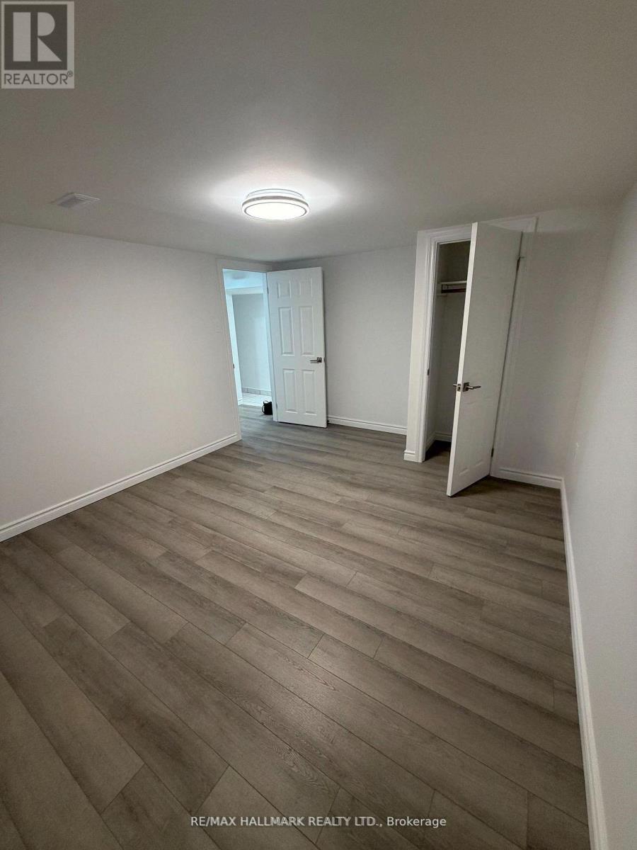 A room with wooden flooring and white walls.