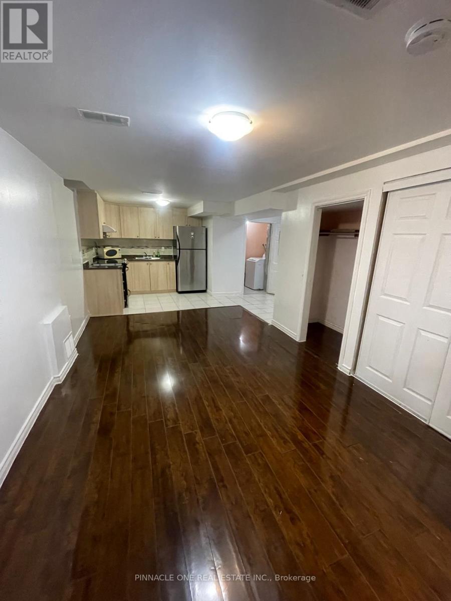A room with wood flooring and white walls.