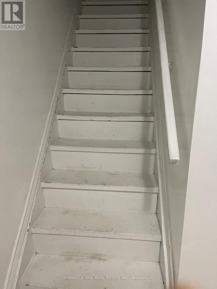 A staircase with a white railing and steps.