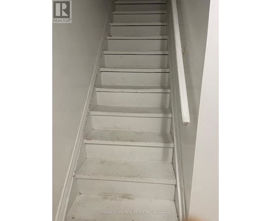 A staircase with a white railing and steps.
