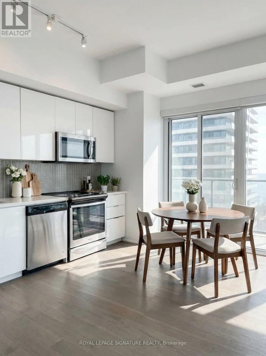 A modern kitchen with a dining table set for four.