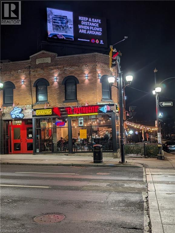 A street view of a building with a sign that reads "Keep a safe distance when plows are around.".
