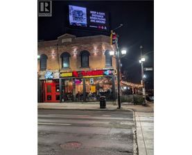 A street view of a building with a sign that reads "Keep a safe distance when plows are around.".