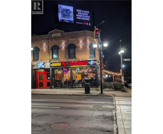 A street view of a building with a sign that reads "Keep a safe distance when plows are around.".