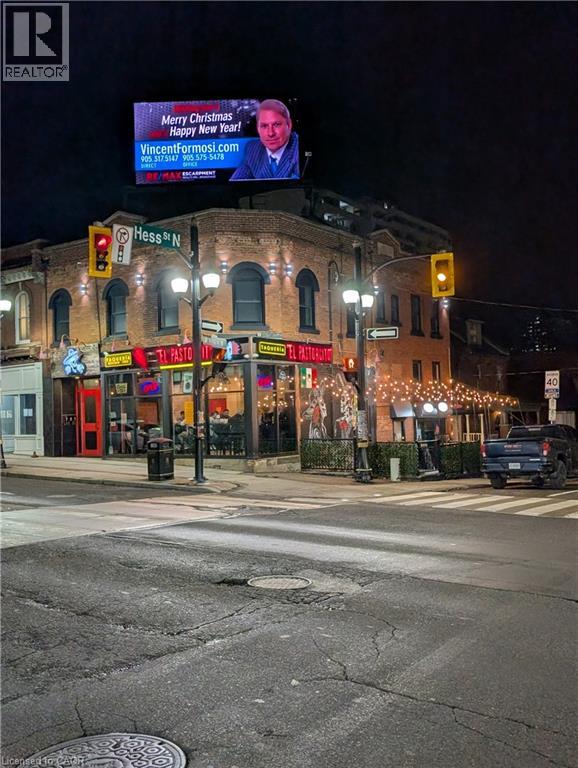 A street view with a billboard that says "Merry Christmas" and a website address.