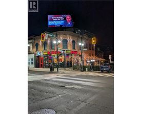 A street view with a billboard that says "Merry Christmas" and a website address.