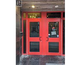 A red door with a glass window and a sign that says "PARENTAL ADVISORY".