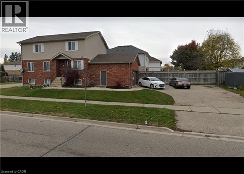 A house with a white car parked in front of it.