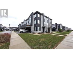 A row of houses with a white car parked in front of one.